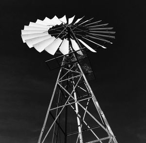 Low angle view of traditional windmill against sky at night