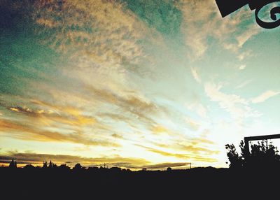 Silhouette of landscape against sky at sunset