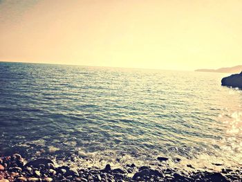 Scenic view of sea against sky at sunset