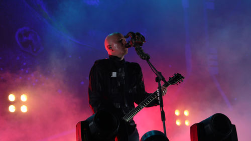 Man playing guitar at music concert