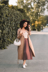 Young woman wearing hat standing outdoors