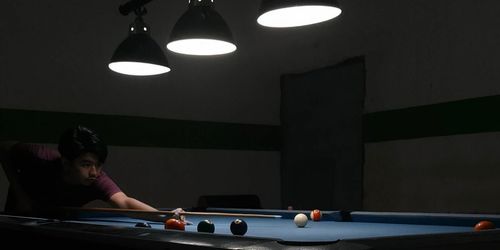 Portrait of boy playing pool