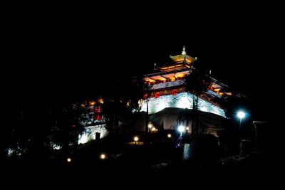 Low angle view of illuminated buildings at night