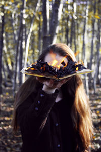 Close-up of woman burning a book