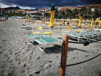 Empty chairs and tables on beach