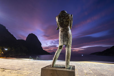 Beautiful sunrise view from beachfront statue to ocean and mountain