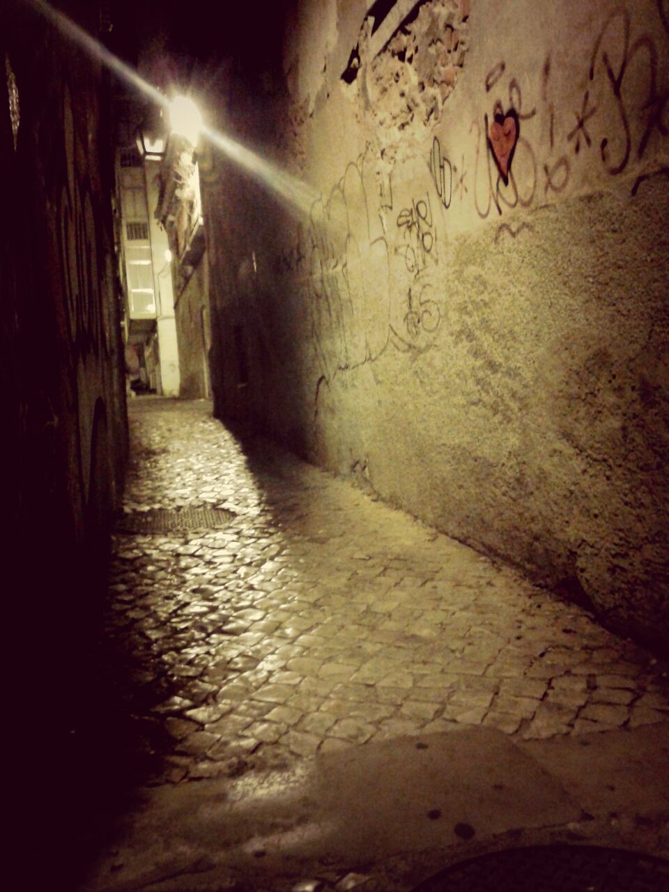 architecture, built structure, night, illuminated, the way forward, building exterior, graffiti, wall - building feature, indoors, street, building, tunnel, wall, wet, city, no people, narrow, diminishing perspective, rain, text