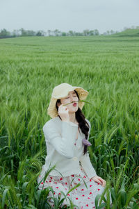 Young woman standing on field