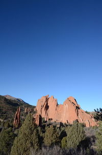 Scenic view of rocky mountains against clear blue sky