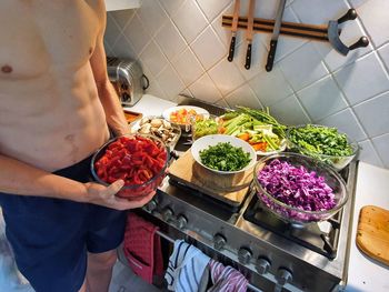 Midsection of man preparing food at home