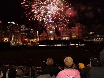 Firework display in city at night