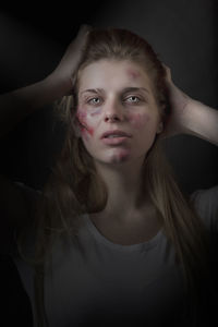 Portrait of a beautiful young woman over black background