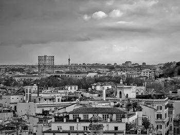 Buildings against cloudy sky