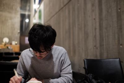 Man writing while sitting at home