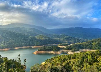 Scenic view of lake and mountains against sky