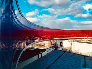 Bridge over river in city against sky