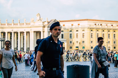 Friends standing at historical building in city