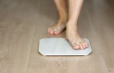 Low section of person standing on table