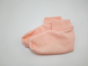 High angle view of pink paper against white background