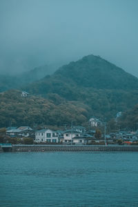 Scenic view of buildings and mountains against sky