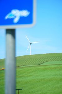 Windmill on field against sky