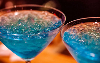 Close-up of martini glass with blue drink