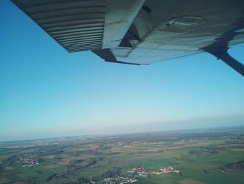 Aerial view of city against clear blue sky