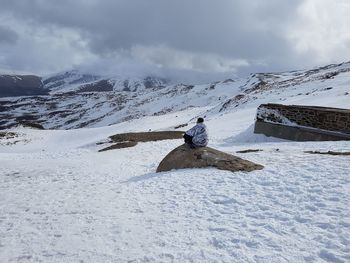 Man on snow field against sky