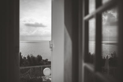 View of sea through window