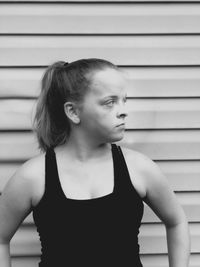 Portrait of woman standing against wall