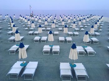 High angle view of chairs at beach against sky