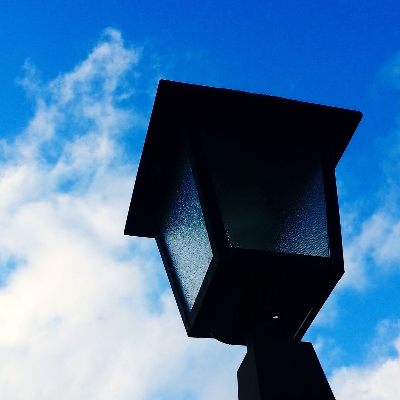 low angle view, architecture, built structure, building exterior, sky, blue, cloud, cloud - sky, outdoors, day, no people, sunlight, tower, high section, building, tall - high, silhouette, nature, directly below, part of