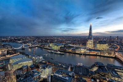 High angle view of city buildings against cloudy sky