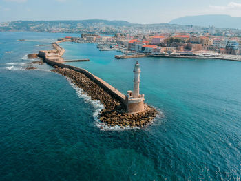 High angle view of sea and buildings against sky