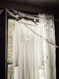 White textile hanging against window at home
