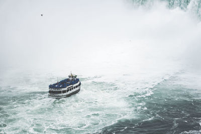 Boat sailing in sea against sky