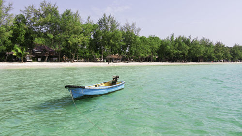 Man in boat on sea against sky