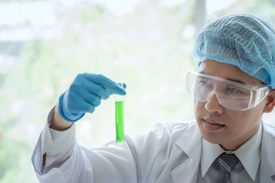 Scientist analyzing test tube at laboratory