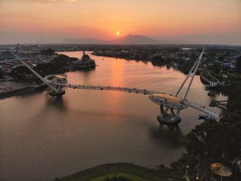High angle view of darul hana bridge over river in city during sunset