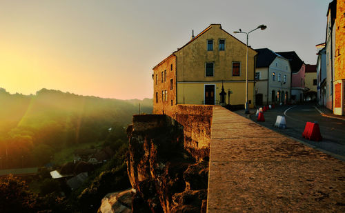 Houses against sky during sunset