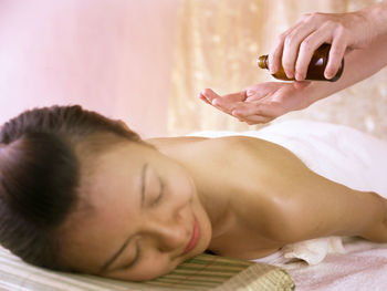 Close-up of woman giving massage to customer at spa