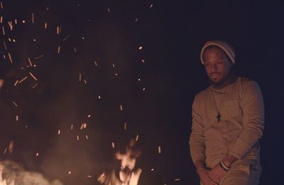 Man looking at bonfire