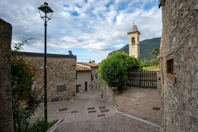 Street amidst buildings against sky