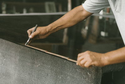 Midsection of carpenter measuring table