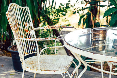 Close-up of empty chairs on table in yard