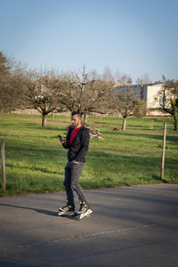 Full length of man standing on road against sky