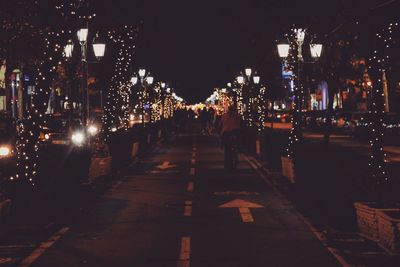 Illuminated city street at night