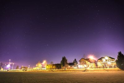 Illuminated building against sky at night