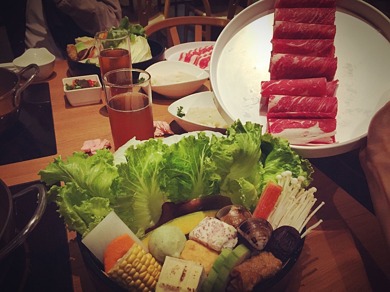 food and drink, food, freshness, table, healthy eating, indoors, vegetable, still life, plate, high angle view, variation, potted plant, restaurant, bowl, ready-to-eat, fruit, leaf, salad, wood - material, meat