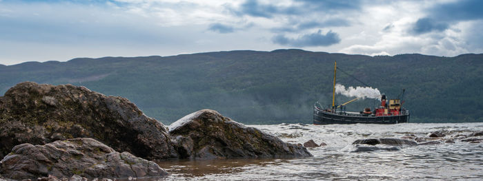 Panoramic view of sea and mountains against sky